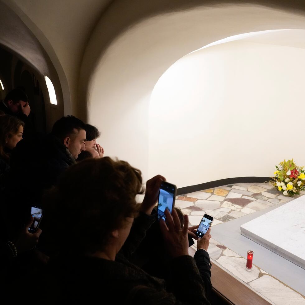 Fieles visitan la tumba del papa emérito Benedicto XVI en la cripta de la Basílica de San Pedro en El Vaticano.