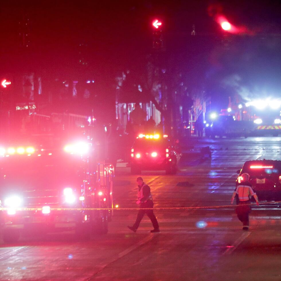 Police investigate at the scene of a crash involving multiple people and injuries at a holiday parade in Waukesha, Wis., on Sunday, Nov. 21, 2021. (Mike De Sisti/Milwaukee Journal-Sentinel via AP)