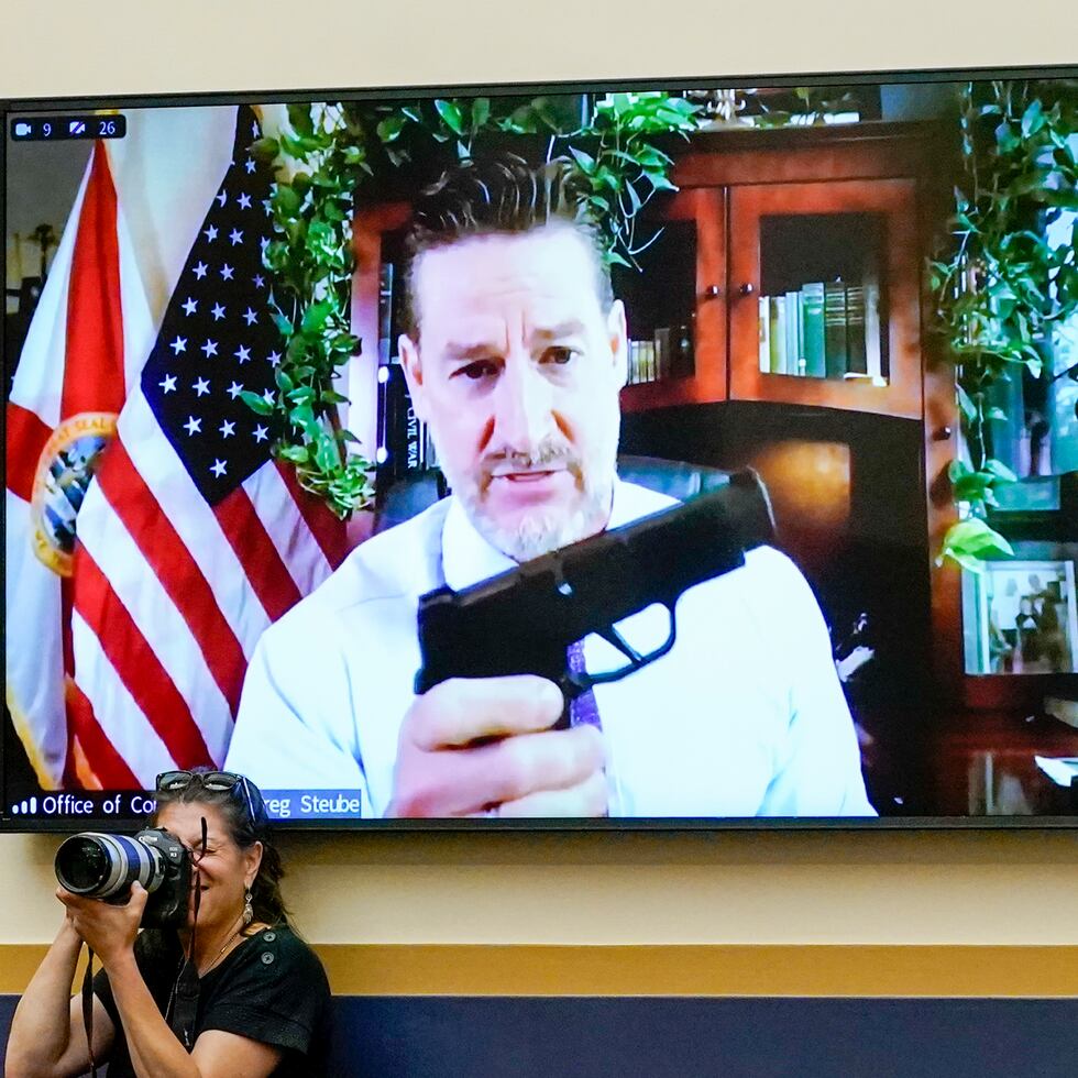 Rep. Greg Steube, R-Fla., holds up his own handgun as he speaks via videoconference as the House Judiciary Committee holds an emergency meeting to advance a series of Democratic gun control measures, called the Protecting Our Kids Act, in response to mass shootings in Texas and New York, at the Capitol in Washington, Thursday, June 2, 2022. (AP Photo/J. Scott Applewhite)