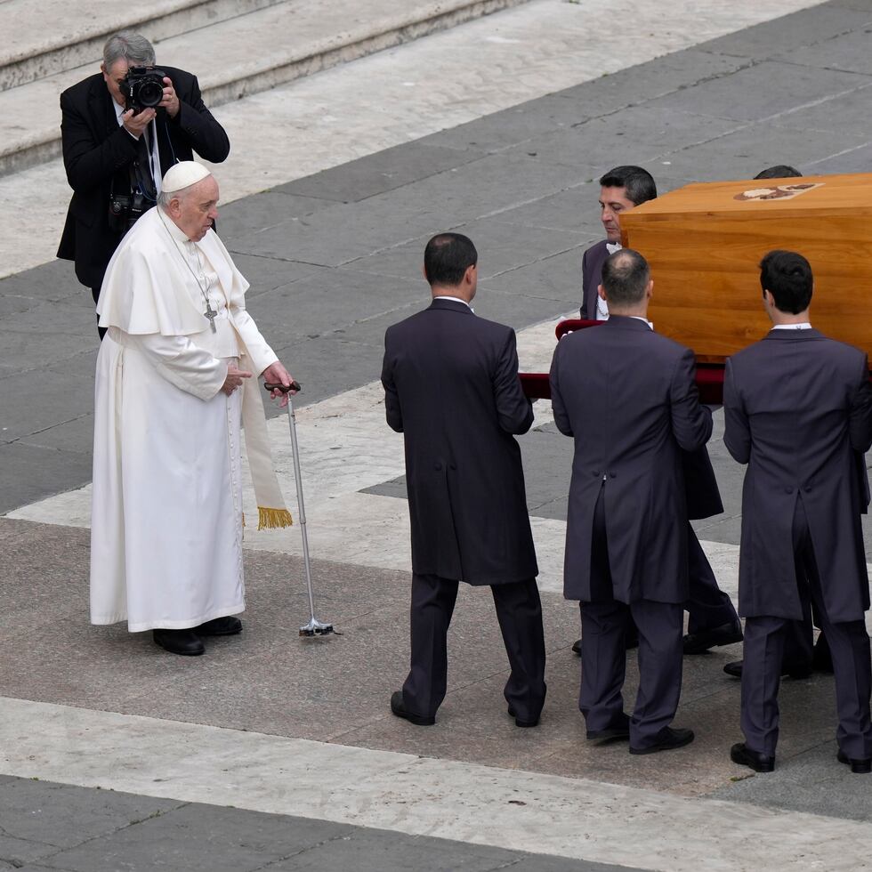 Pope Francis stands in front of the coffin of late Pope Emeritus Benedict XVI being carried away after a funeral mass in St. Peter's Square at the Vatican, Thursday, Jan. 5, 2023. Benedict died at 95 on Dec. 31 in the monastery on the Vatican grounds where he had spent nearly all of his decade in retirement. (AP Photo/Ben Curtis)