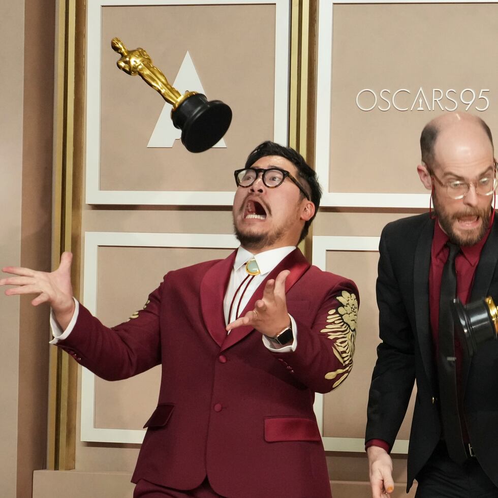 Daniel Kwan, left, and Daniel Scheinert toss their awards for best picture for "Everything Everywhere All at Once" as they pose in the press room at the Oscars on Sunday, March 12, 2023, at the Dolby Theatre in Los Angeles. (Photo by Jordan Strauss/Invision/AP)