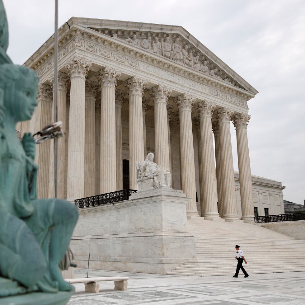 A police officer walks outside the Supreme Court on Capitol Hill in Washington, Monday, July 6, 2020. (AP Photo/Patrick Semansky)