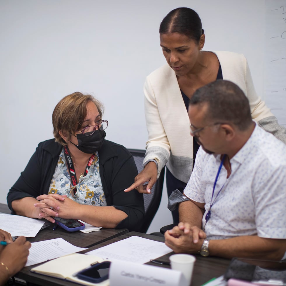 Los nueve participantes del programa viajarán, este mes, a Miami para conocer su distrito escolar.  Arriba, tres de los participantes junto a la directora de Reforma Estructural de Educación de la JSF, Karen Maldonado.