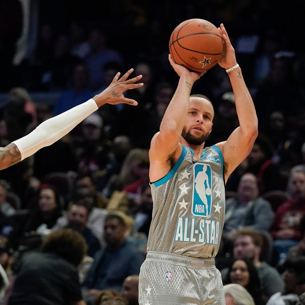 Stephen Curry, derecha, de los Warriors de Golden State, intenta un triple ante la marcación de Ja Morant, de los Grizzlies de Memphis, en el Juego de Estrellas de la NBA.