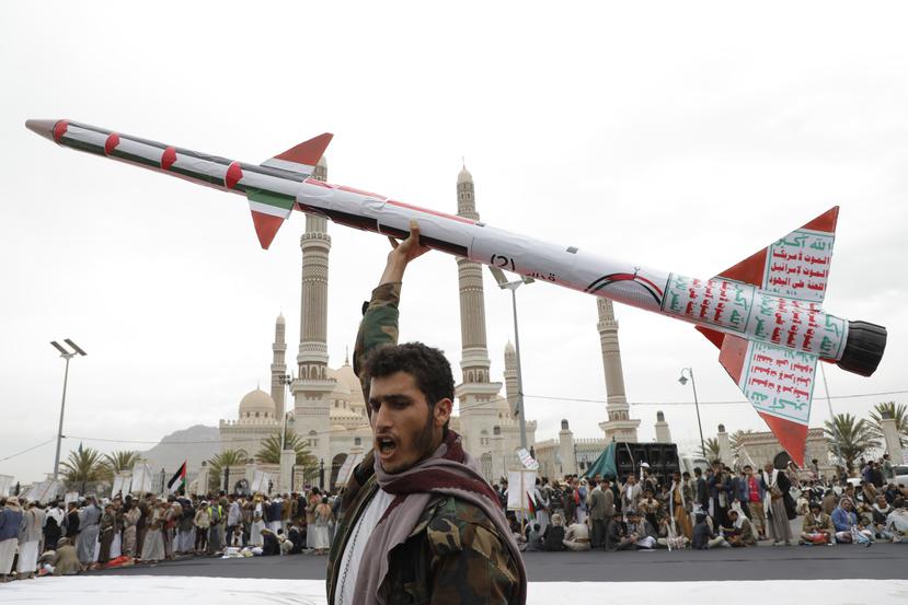 Un partidario de los hutíes levanta un cohete de imitación en una marcha contra Estados Unidos e Israel y en apoyo a los palestinos en la Franja de Gaza