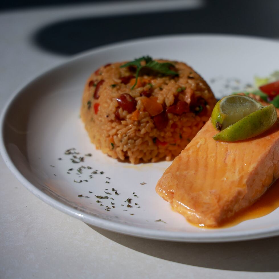 El salmón en salsa de mangó es una de las especialidades en los platos principales. En la foto, acompañado de arroz mampoteao.