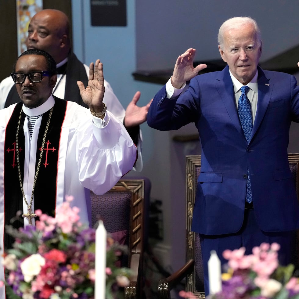 El presidente Joe Biden, a la derecha, y el pastor J. Louis Felton rezan en un servicio religioso en la Iglesia de God in Christ de Mount Airy.