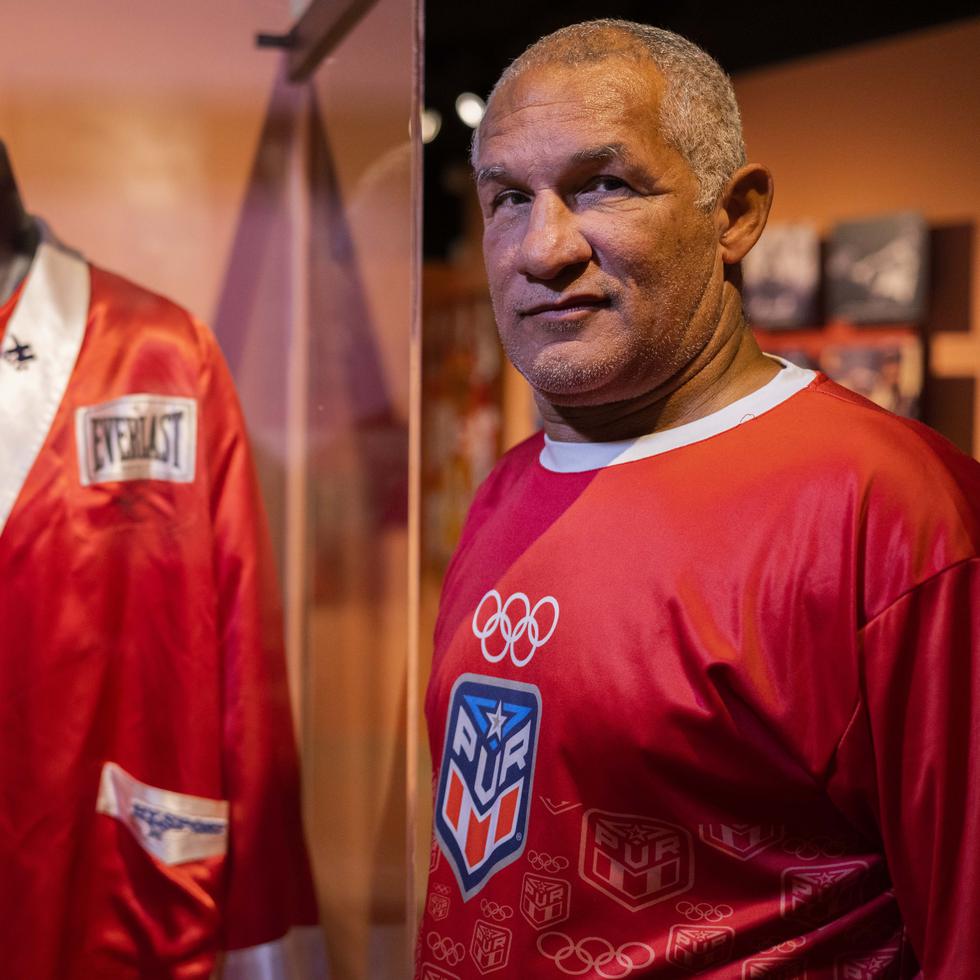 Luis Francisco Ortiz next to the robe he wore at the 1984 Olympic Games.